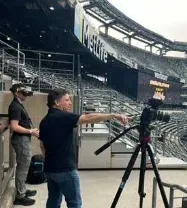 Video production crew filming inside an arena