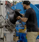 Manufacturing technician working on industrial equipment